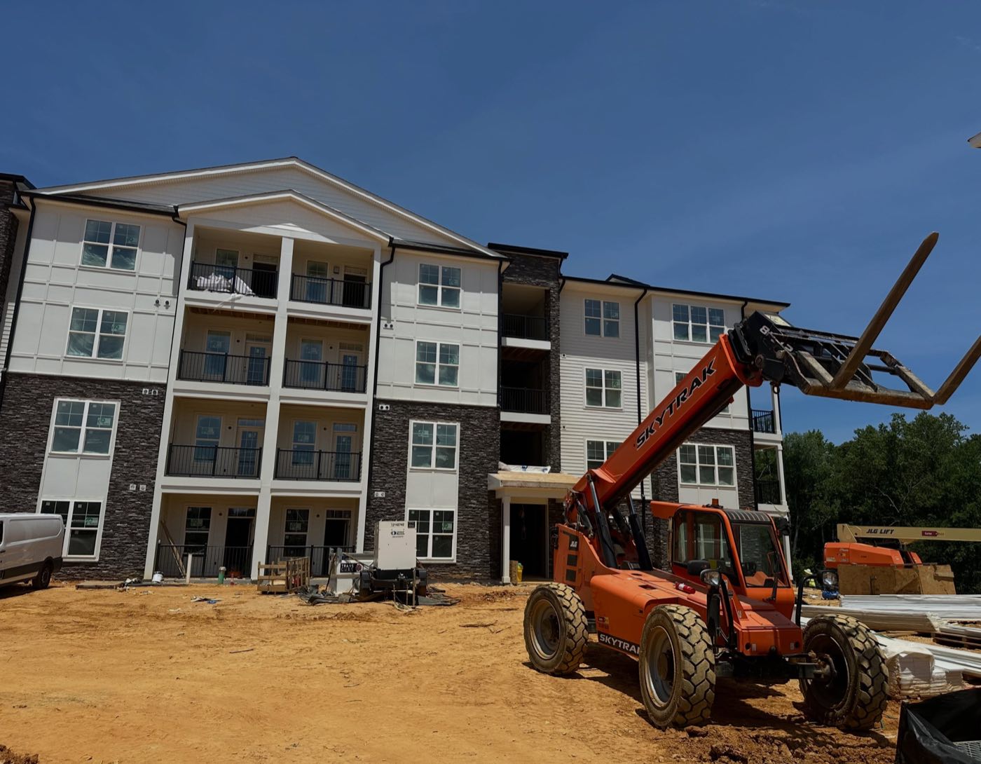 A residential building at The Simmons with completed siding and stone veneer during construction